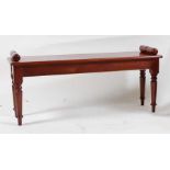 A Victorian style mahogany window seat, on ring turned tapering end supports, w.116cm, d.33cm, h.