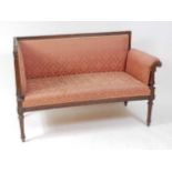 A late 19th century continental walnut framed settee, having acanthus leaf capped arms, fluted