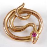 An early 20th century yellow metal snake brooch, set with a 4.4 x 4.5mm ruby in the head with two