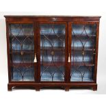 A mahogany glazed bookcase, in the late Georgian style, the three astragal glazed doors enclosing