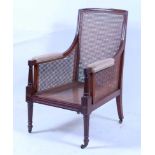 *A 19th century mahogany bergère library armchair, having single cane back, seat and sides, on