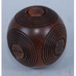 A carved treen puzzle ball, inlaid with roundels of diamonds surrounded by ribbed bands, with push-