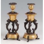 A pair of late 19th century French bronze and gilt bronze candlesticks, the floral cast removable