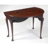 A George II red walnut gateleg dining table, possibly Irish, having heavy one-piece oval fall leaves