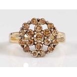 A 9ct yellow gold diamond circular cluster ring, featuring nineteen fancy light brown diamonds in