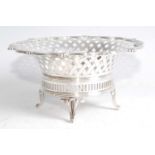 An Edwardian silver bonbon dish, of shaped circular form with lattice worked flaring rim, raised