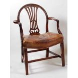 *A George III mahogany elbow chair, in the Heppelwhite manner, having bellflower carved arched back,