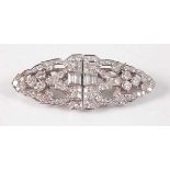 A white metal oblong Art Deco style diamond panel brooch, featuring a centre section of four