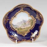 An early 20th century Meissen porcelain small dish, decorated with a view of Rathen within a