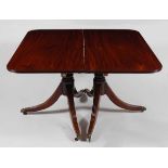 *A Regency mahogany twin pedestal dining table, the top having a reeded edge and two extra leaves (