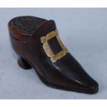 A mid-19th century treen shoe-snuff, having faux ivory and penwork buckle, the sliding cover with