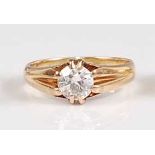 A yellow metal diamond solitaire ring, comprising a round brilliant cut diamond in an eight-claw