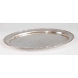 A circa 1900 Middle Eastern white metal tray, having a raised leaf cast rim, annotated in Arabic,