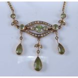 A 9ct yellow gold Edwardian style peridot and seed pearl pendant, comprising three pear shaped and