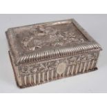 *A late Victorian silver dressing table box, the hinged cover chased with an allegorical scene