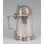 A mid-Victorian silver lidded tankard, in the medieval style and of cylindrical form, the hinged