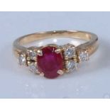 A yellow metal, ruby and diamond dress ring, comprising a centre oval faceted ruby with a trefoil of