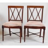 *A pair of Sheraton period painted satinwood dining chairs, each having lattice worked backs with