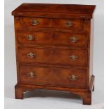 A George I style walnut bachelors chest, the rectangular feather strung fold-over top above four