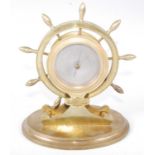A late 19th century lacquered brass cased novelty barometer, the unsigned silvered dial set within a