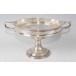 A George V silver pedestal comport, having a Greek Key pierced gallery and applied twin handles,