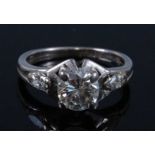 A white metal diamond single solitaire ring, featuring a round brilliant cut diamond in a four-