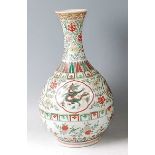 *A Chinese porcelain bottle vase, in the famille verte palette, brightly enamel decorated with