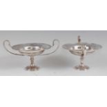 A pair of Edwardian silver pedestal comports, having twin handles and raised on knopped waisted