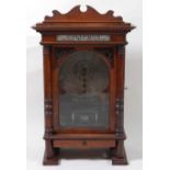 A late 19th century walnut cased free standing and coin operated Polyphon by Nicole Freres of