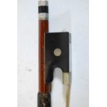 A German nickel mounted violin bow having an ebony frog with mother of pearl eye, stamped W.