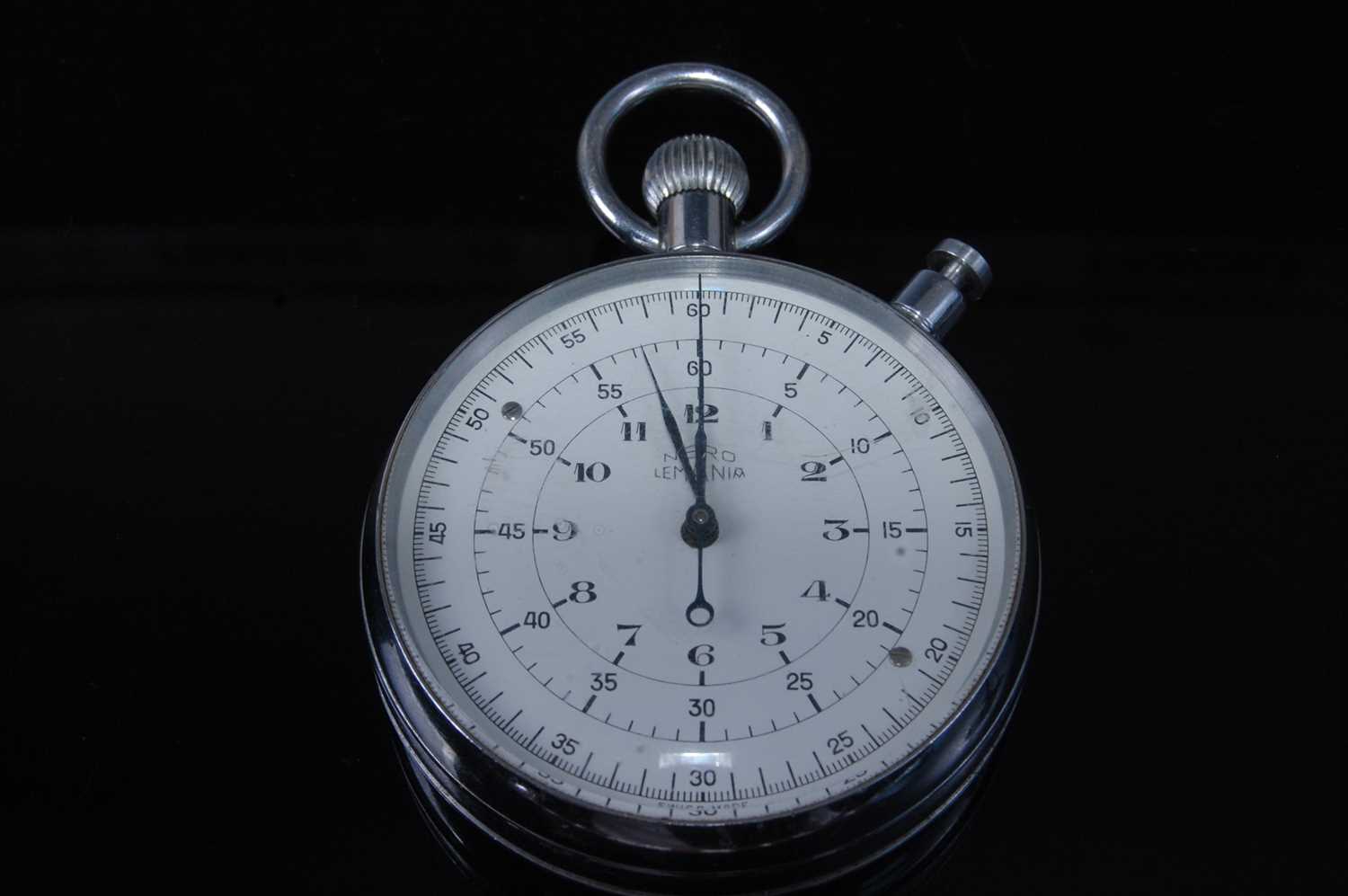 A Nero Lemania nickel cased chronograph stopwatch, the enamel dial with Arabic numerals, the case