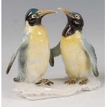Karl Ens - an early 20th century glazed porcelain figure group of a pair of Emperor Penguins,