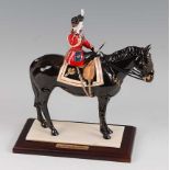 A Coalport limited edition figurine 'Trooping the Colour', underglaze painted and heightened in