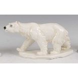 Karl Ens - a circa 1930s glazed porcelain model of a Polar Bear, in prowling pose, raised on