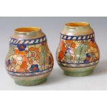 Charlotte Rhead for Crown Ducal - a pair of 1930s pottery squat vases, each of gourd form, bright