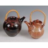 A studio pottery Tenmoku glazed teapot and cover, having applied cane handle, of mid-bulbous
