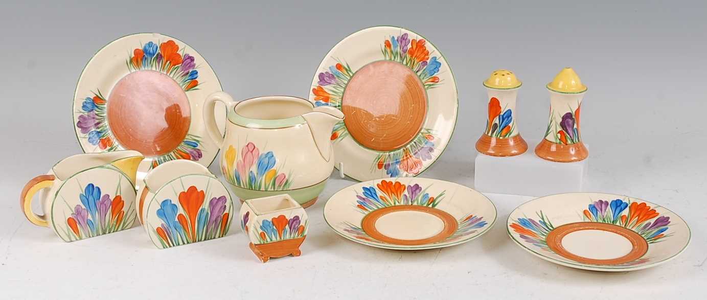 A collection of 1930s Clarice Cliff pottery tablewares in the Crocus pattern, to include a pair of