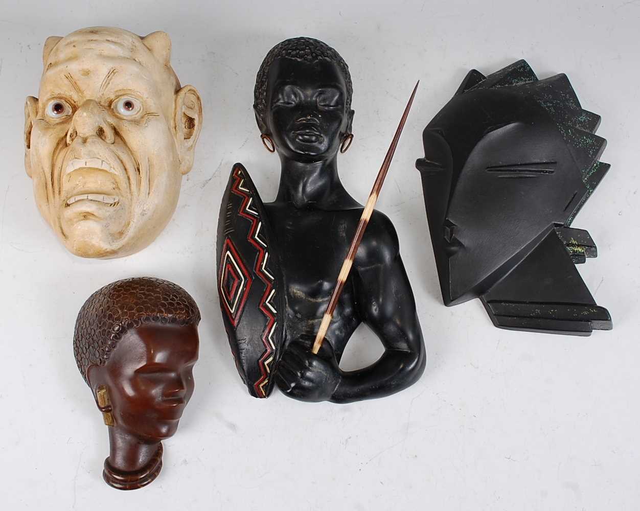 A collection of four various mid 20th century pottery wall masks, to include; Austrian example