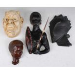 A collection of four various mid 20th century pottery wall masks, to include; Austrian example