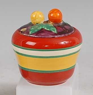 A 1930s Clarice Cliff Bizarre pattern preserve pot and cover, of slightly shouldered form, painted