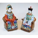 A pair of 20th century Chinese pottery figures of seated Emperors, each in formal dress, h.31cm