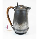 An early 20th century hammered pewter hot water jug, of ovoid form, stamped 'Connell 53 Cheapside'