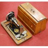 A Frister & Rossmann walnut cased sewing machine