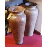 A pair of 20th century Bali Bullel urns, each with a flared rim and tapered body, each h.82cm