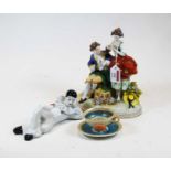 A reproduction continental porcelain figure group in the 18th century style together with a china
