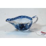 An 18th century Bow porcelain relief moulded sauceboat, blue & white transfer printed with