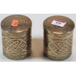 A pair of Middle Eastern engraved white metal cylindrical jars and covers, h.9cm