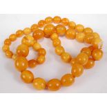 A beaded and knotted faux butterscotch amber necklace, 74cm, 83g