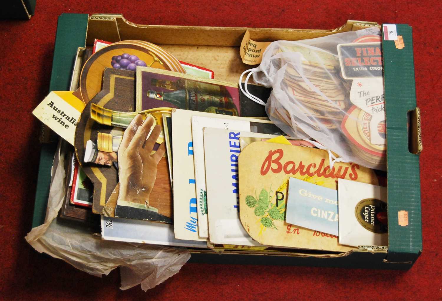 A box containing a collection of breweryana, to include various advertising signs and beer mats