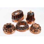 A Victorian copper castle-top jelly mould by Benham & Froud, h.14cm; together with four other 19th